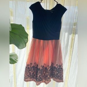 Pink and black middy dress with detail.